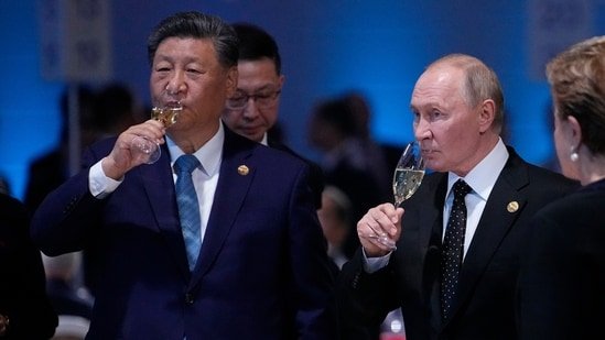 Russian President Vladimir Putin and Chinese President Xi Jinping hold glasses during a festive reception of the BRICS summit in Russia. (AP File Photo)