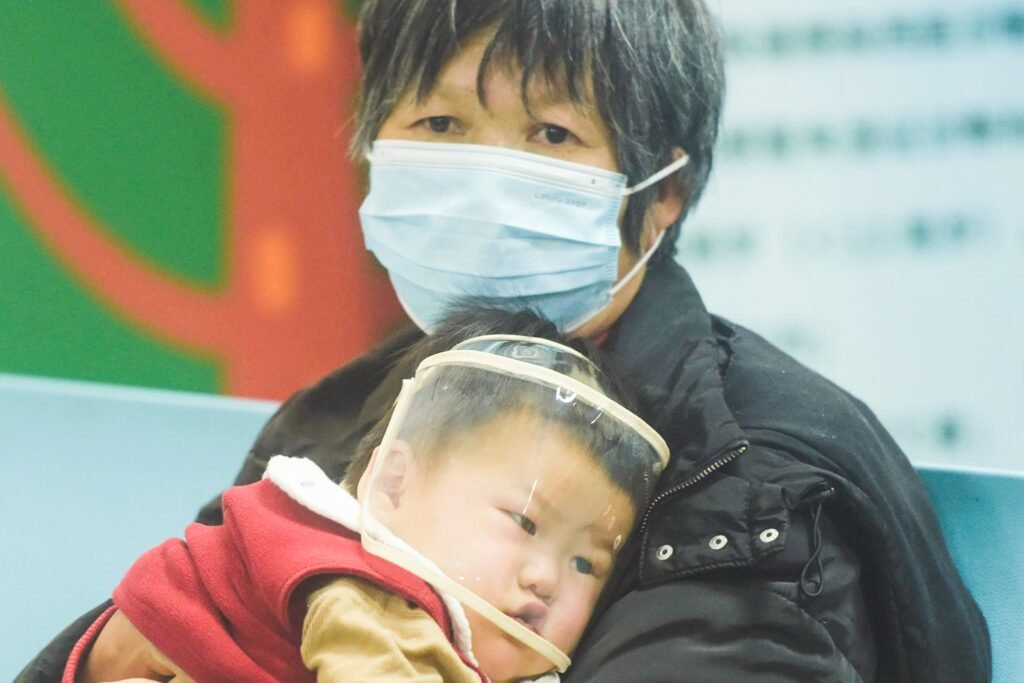 A child, accompanied by their parents, sees a doctor at a pediatric department of a hospital in Hangzhou, China