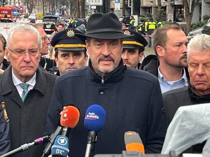 Bavaria's Minister President Markus Soeder (C), Interior Minister Joachim Herrmann (L) and Dieter Reiter (R) make a statement at a crime scene in Munich city center, where a vehicle drove into a group of people. At least 20 people were injured, some of them very seriously, after a car crashed into a crowd on Stiglmaierplatz before 11 am (1000 GMT) on Thursday, according to a Munich fire brigade spokesman. Christoph Trost/dpa