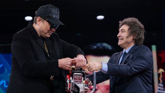 Elon Musk, left, receives a chainsaw from Argentina's President Javier Milei at the Conservative Political Action Conference, CPAC, at the Gaylord National Resort & Convention Center, Thursday, Feb. 20, 2025, in Oxon Hill, Md. (AP Photo/Jose Luis Magana)