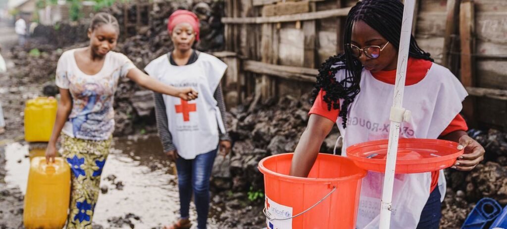 A UNICEF-supported cholera team add chlorine to water collected from a reservoir in Goma, in the DR Congo.