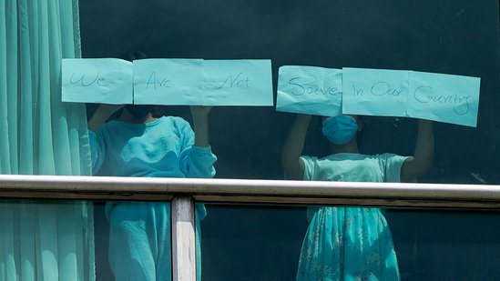 Migrants deported from the US place papers with a written message in the window of the Decapolis Hotel where they are temporarily staying in Panama City, February 18, 2024. (AFP)