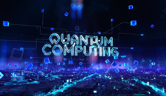 The words quantum computing are shown against a black and blue background.