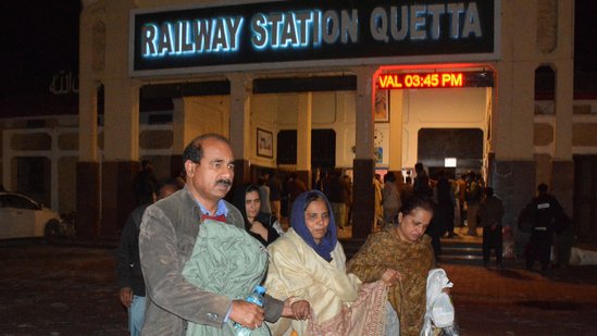 Passengers who were rescued from a train after it was attacked by separatist militants, walk with their belongings at the Railway Station in Quetta, Balochistan, Pakistan, March 12, 2025. (REUTERS)