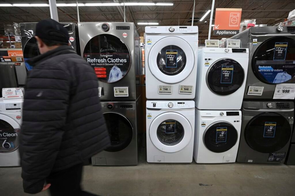 A man walks past washing machines at a Home Depot. Such appliances could cost more after President Donald Trump imposed 25% steel and aluminum tariffs.