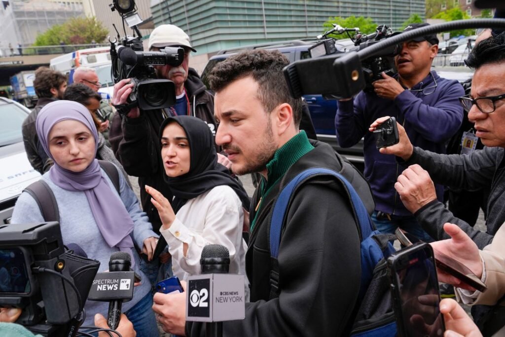 Members of the Columbia University Apartheid Divest group, including Sueda Polat, second from left, and Mahmoud Khalil, center, are surrounded by members of the media in April 2024 outside the Columbia University campus in New York.