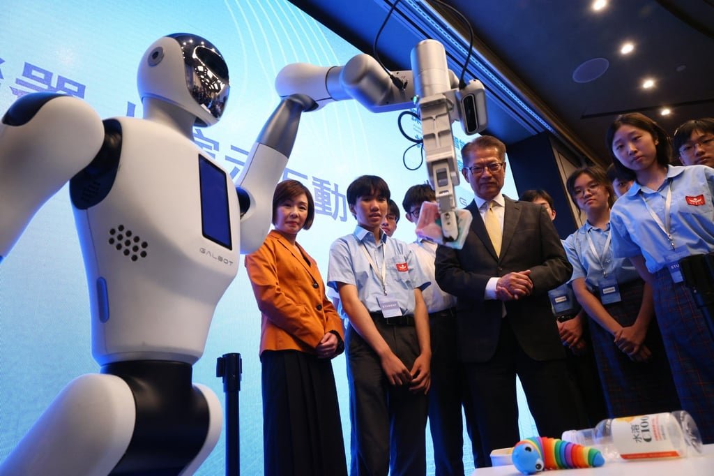 Finance chief Paul Chan watches a robot demonstration at launch ceremony for Hong Kong Investment Corporation and Galbot related to their joint push in AI at the Island Shangri-La. Photo: Dickson Lee