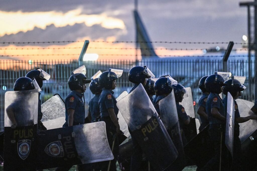 Police gather outside Villamor Air Base, where former Philippine president Rodrigo Duterte was held after his arrest in Manila on March 11, 2025.