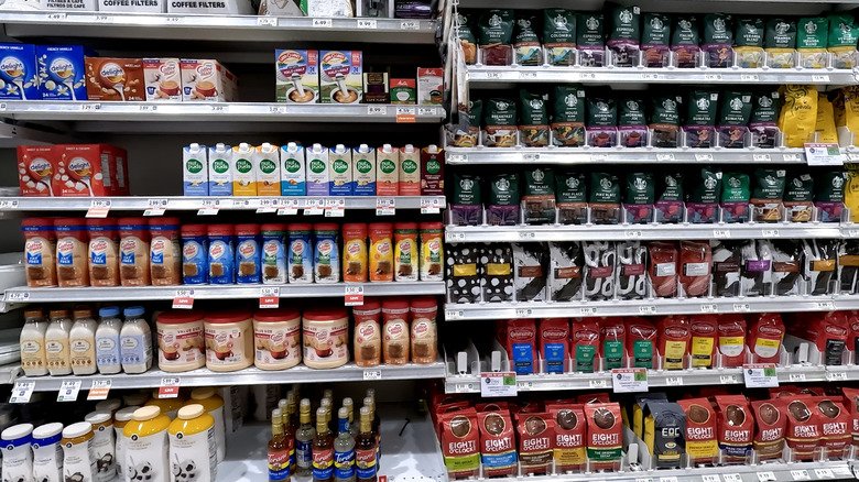 A grocery store shelf full of coffee creamer