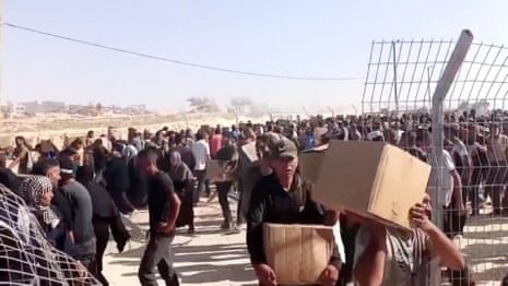 Gunfire heard as thousands rush to receive aid at Gaza distribution centre – video