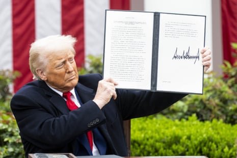 Donald Trump in the Rose Garden of the White House holding up a just signed executive order at a “liberation day'’ event where the president signed an executive order creating reciprocal tariffs.
