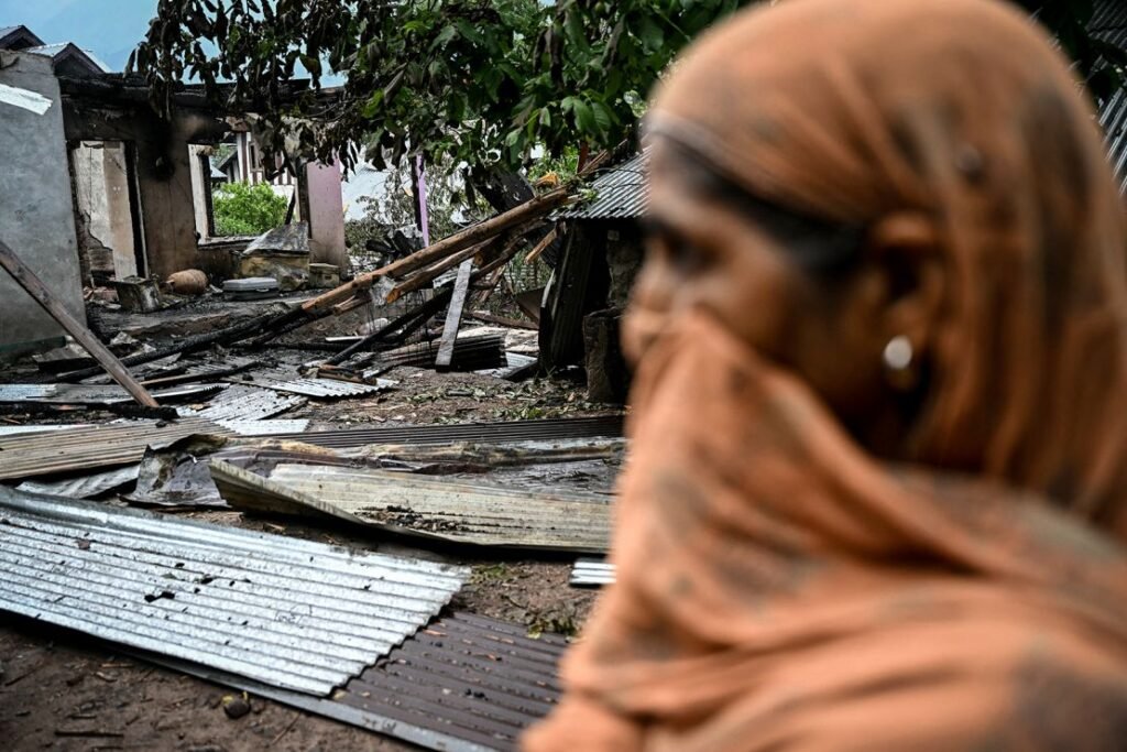 A woman stands outside a house destroyed by Pakistani artillery shelling at the Salamabad village in Uri, about 110kms from Srinagar, on May 8, 2025.