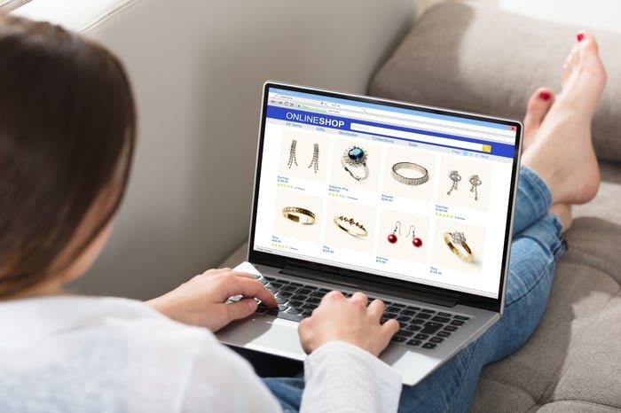 Person browsing an e-commerce site on a laptop.