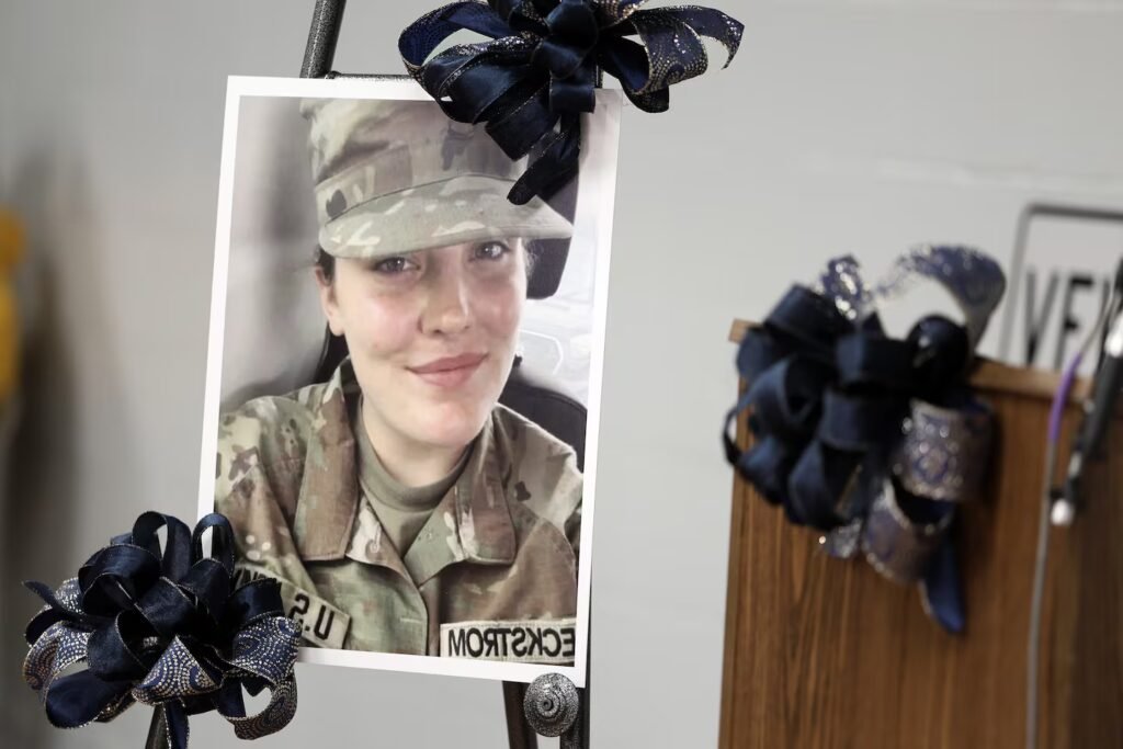 A picture of US Army Specialist Sarah Beckstrom, one of two National Guard members who were shot in Washington on Wednesday, is honored with blue bows in Webster Springs, W.Va. on Friday.