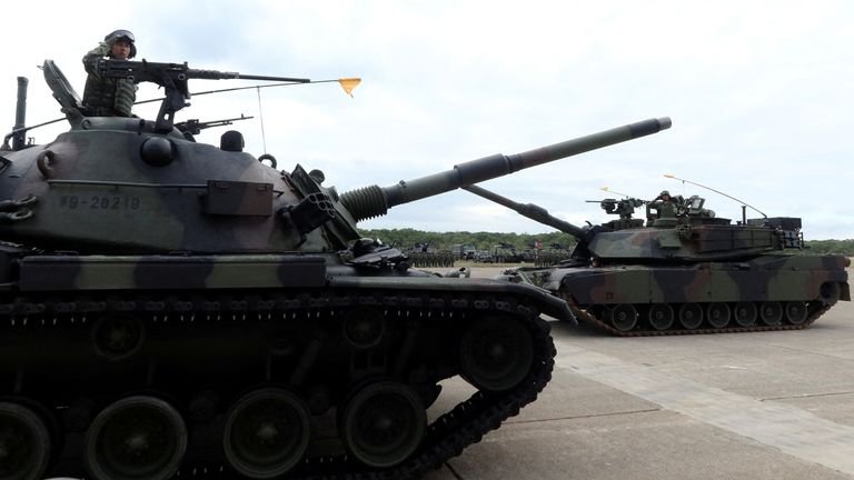 Taiwan's first battalion of M1A2T Abrams tanks and (below) sea mines being loaded at a military base. Pics: Reuters