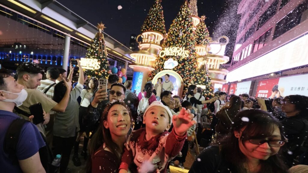 Christmas Eve crowds gather in Hong Kong but festive atmosphere ‘more subdued’