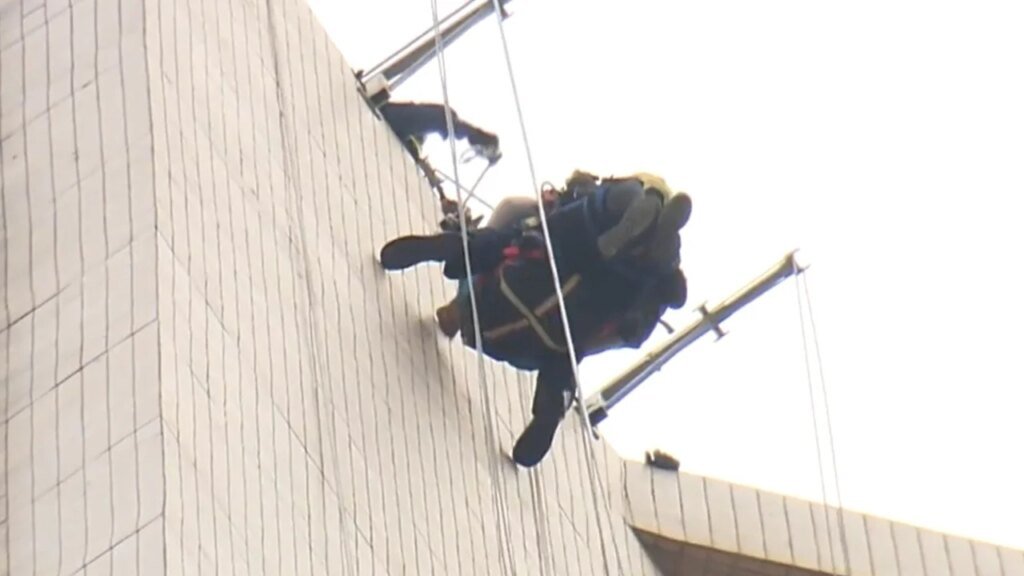 High drama in Hong Kong as tilting gondola traps 2 workers on luxury tower