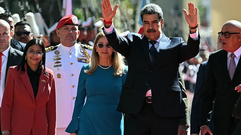 Venezuela's President Nicolas Maduro with his arms in the air.
