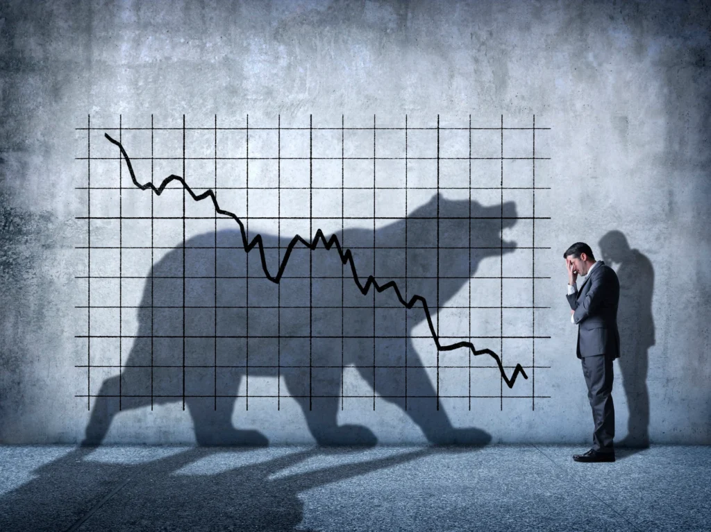 Silhouette of a bear with a stock market crash chart.