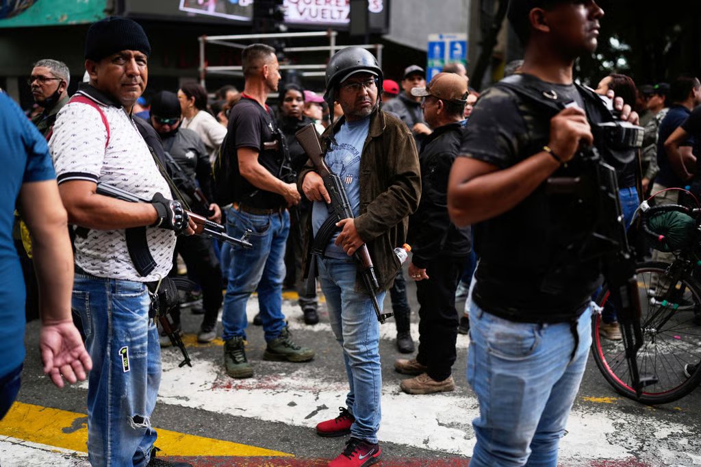 Pro-government, armed civilians at a protest in Caracas, Venezuela on Sunday. Photo: AP