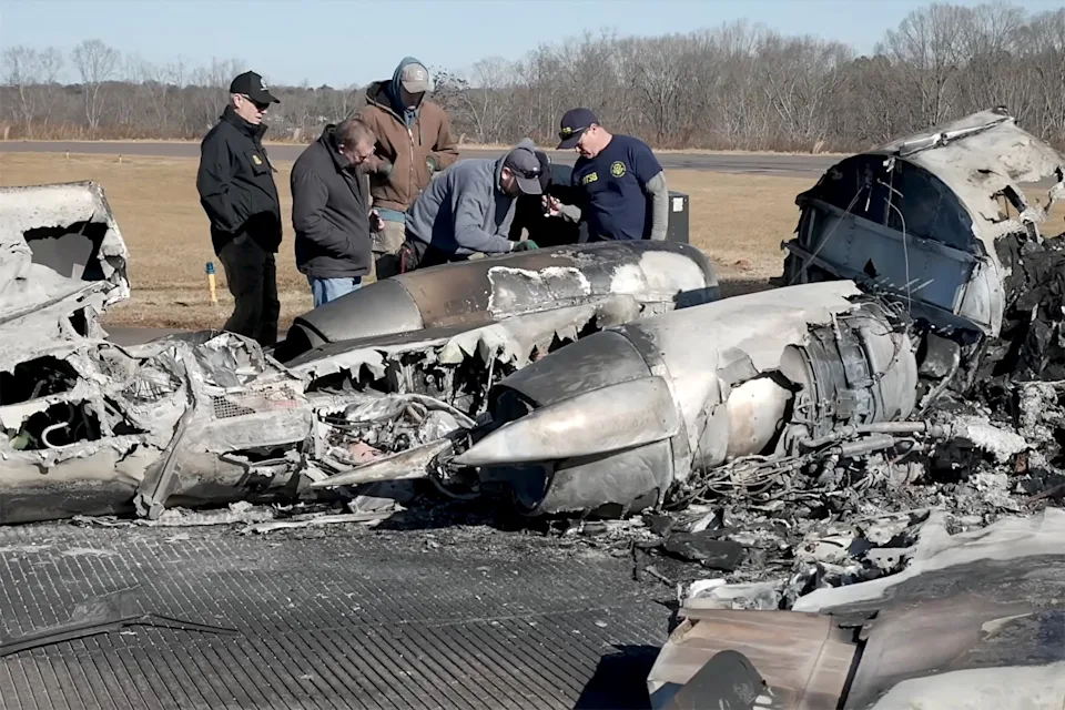 National Transportation Safety Board (NTSB) investigators view the wreckage of a Cessna 550 business jet after several people, including former NASCAR driver Greg Biffle, were killed in a crash during severe weather, at Statesville Regional Airport in Statesville, North Carolina, U.S. December 19, 2025 in a still image from a handout video. NTSB/Handout via REUTERS. THIS IMAGE HAS BEEN SUPPLIED BY A THIRD PARTY TPX IMAGES OF THE DAY