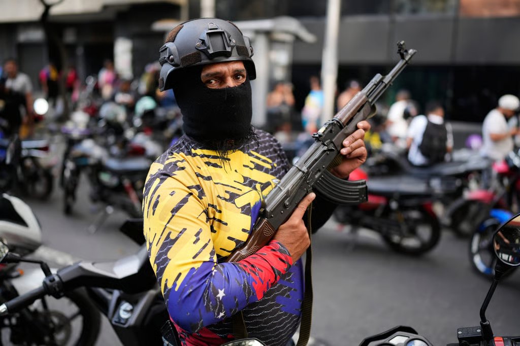 A pro-government, armed civilian in Caracas, Venezuela, attends a protest demanding the release of President Nicolas Maduro. Photo: AP