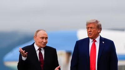 US President Donald Trump and Russia's President Vladimir Putin talk at Joint Base Elmendorf-Richardson, Alaska. (AP)