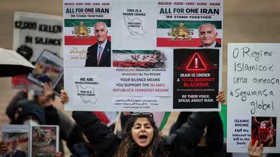 Protestors hold signs and portraits of the son of the last shah of Iran Mohammad Reza Pahlavi, Reza Pahlavi, during a demonstration in support of Iranian People in front of the Portuguese Parliament in Lisbon, on January 17, (AFP)