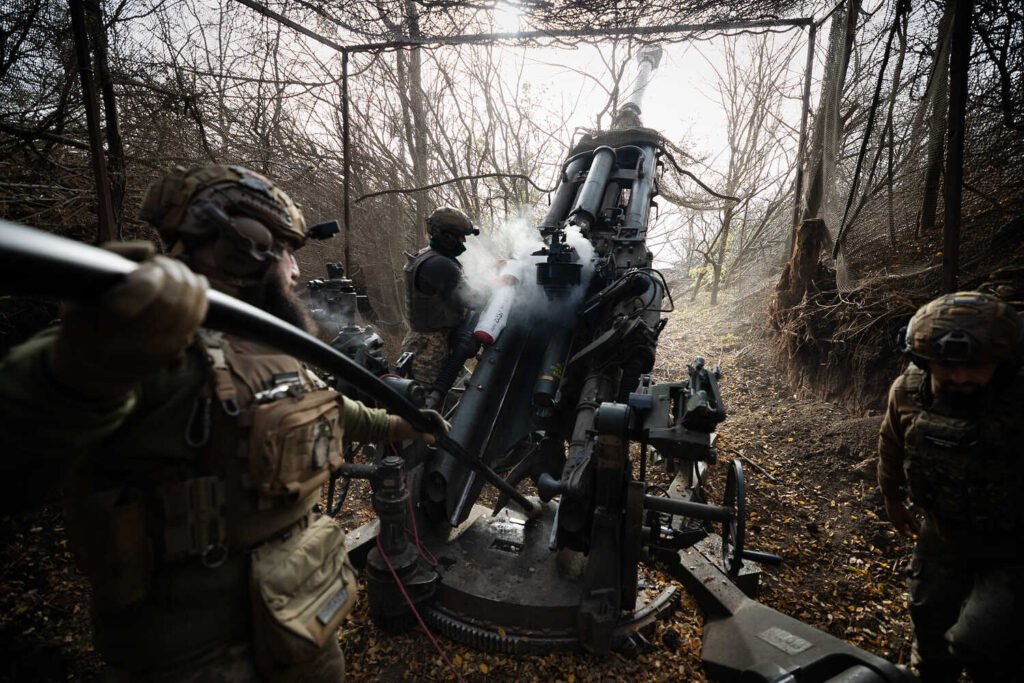 Soldiers firing a howitzer.
