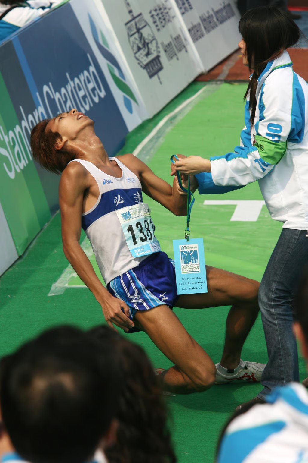 A runner collapsing after crossing the finishing line. More than 40,000 runners took part in marathon, half-marathon and 10-kilometre races on February 12, 2006, amid bad air quality in Hong Kong. Photo: SCMP
