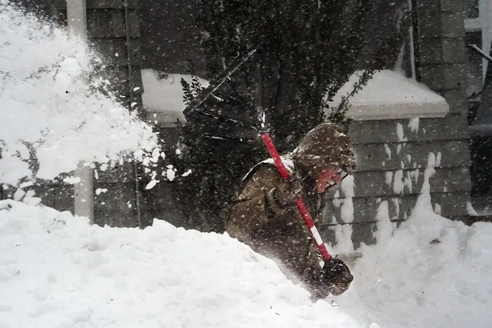 A resident shovels out during the Feb. 23 blizzard as heavy snow and strong winds sweep across the Seacoast.