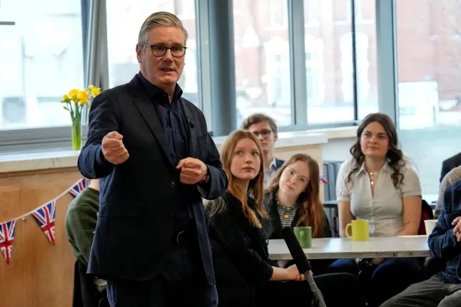 British Prime Minister Keir Starmer speaks to local residents during a visit to a community centre at St Mary's Church in Putney, southwest London, Britain, February 16, 2026. CARLOS JASSO/Pool via REUTERS