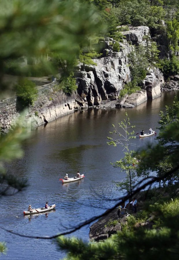 Canoes on a river, seen from above.