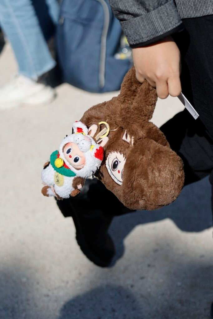 A guest wears brown fur Labubu bag with Labubu charm attached, outside Dior, during the Womenswear Spring Summer 2026 as part of Paris Fashion Week in Paris, France, on October 1, 2025.