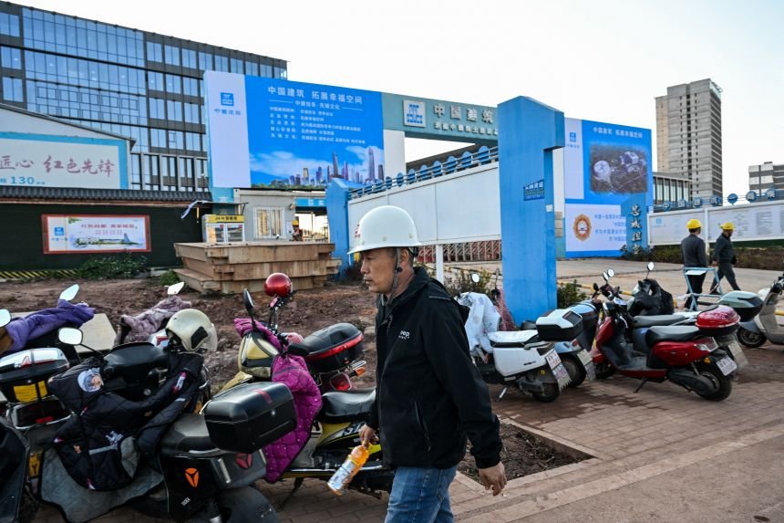 Construction workers are seen at the site of the new headquarters of the China Rare Earth Group in Ganzhou, China, on November 21, 2025