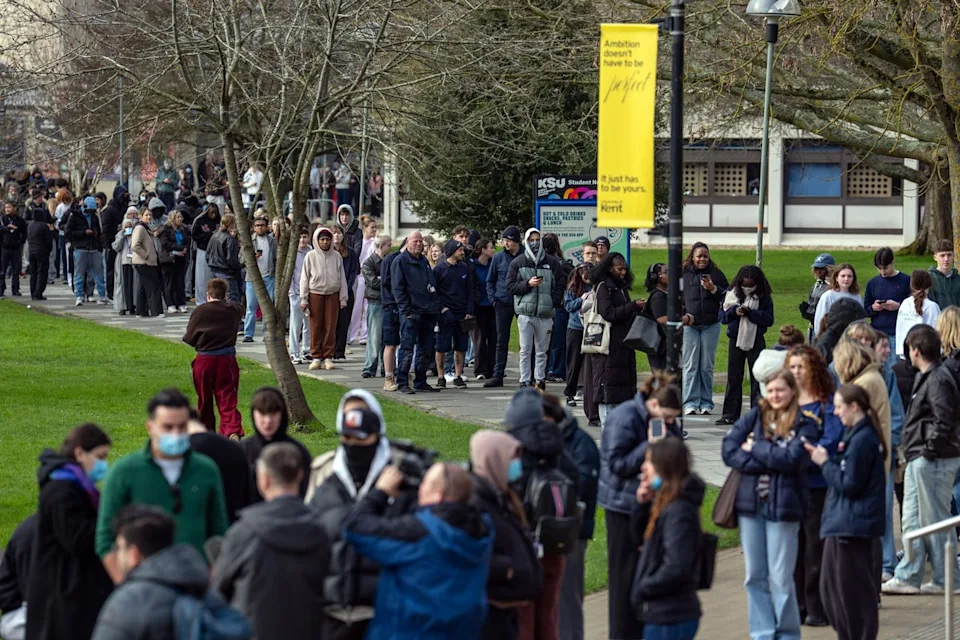 Staff and students, some wearing masks, queue to receive antibiotics at the University of Kent at Canterbury after an outbreak of meningitis caused the deaths of two people (Getty)
