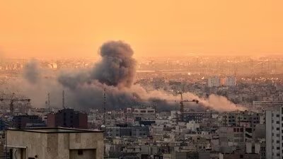 A plume of smoke rises following a US-Israeli military strike in Tehran, Iran. (AP)