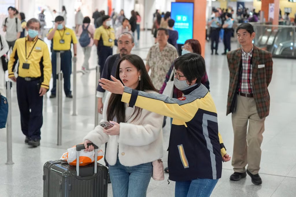 An MTR staff member helps a commuter at Kai Tak station. Photo: Eugene Lee