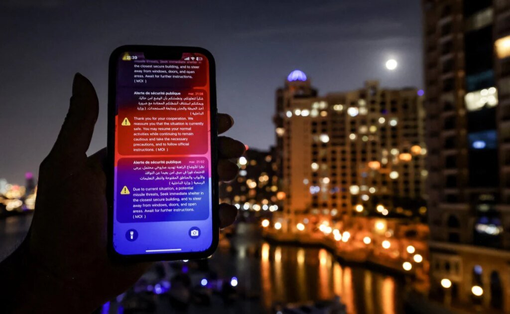 An alert issued by the UAE Ministry of Interior warning residents of Dubai and Abu Dhabi of a potential Iranian missile strike is displayed on a mobile phone shortly before a missile was intercepted in Dubai on March 5