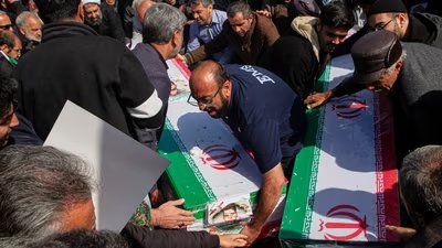 Mourners carry coffins during a funeral for people killed during the ongoing US–Israeli military campaign in Isfahan, Iran. (AP)