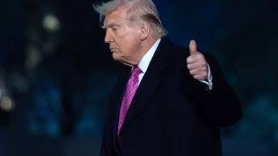 President Donald Trump waves to the media as he walks on the South Lawn upon his arrival at the White House, Sunday in Washington. (AP)