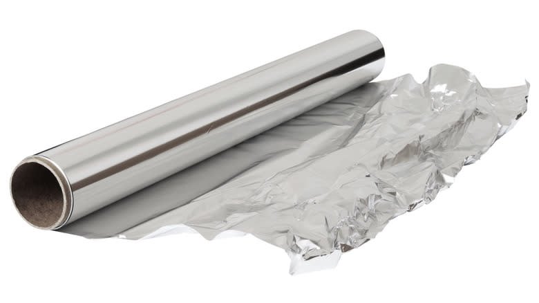 A roll of aluminum foil against a white background