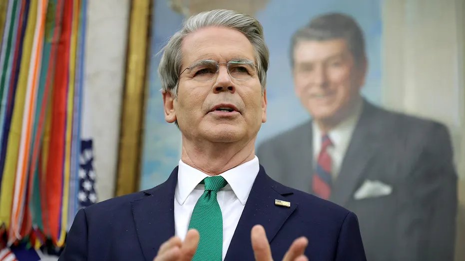 Treasury Secretary Scott Bessent in front of a Ronald Reagan portrait