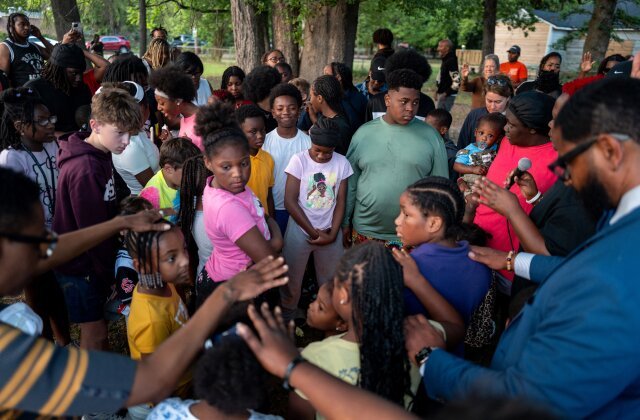 SHREVEPORT, LOUISIANA - APRIL 20: Children huddle to pray during a memorial gathering on April 20, 2026 in Shreveport, Louisiana. Eight children were killed and two women were wounded during a domestic violence incident in the early morning hours of April 19th, according to local authorities. (Photo by Brandon Bell/Getty Images)