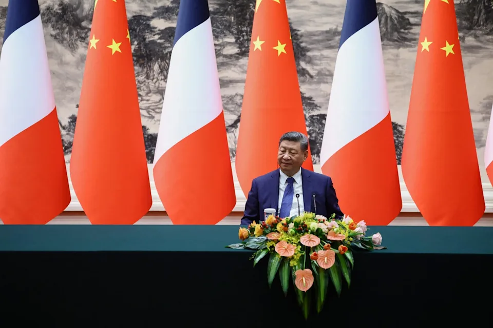 China's president Xi Jinping reacts during a joint press statement with France's president Emmanuel Macron in Beijing on 4 December 2025 (AFP via Getty)