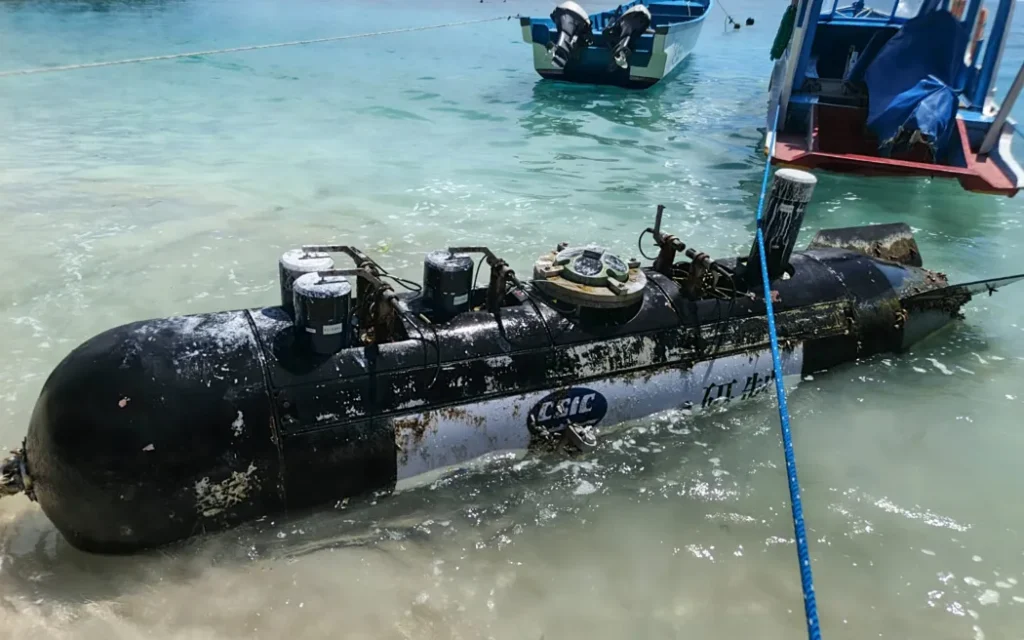 A picture taken on April 6, 2026, shows a torpedo-like 3.7-metre-long and 65-centimetre-wide object, discovered by a fisherman near the Lombok Strait after being towed ashore onto a beach on Gili Trawangan, West Nusa Tenggara. The Indonesian navy said on April 9, it was investigating a torpedo-like object discovered by a fisherman near the Lombok Strait, a key maritime route connecting the Indian and Pacific Oceans. (Photo by AFP)