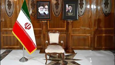 An empty chair sits under the portraits of Iran's late supreme leader Ayatollah Ali Khamenei (left), the late Ayatollah Ruhollah Khomeini (centre) and the new supreme leader Mojtaba Khamenei (right). (AFP)
