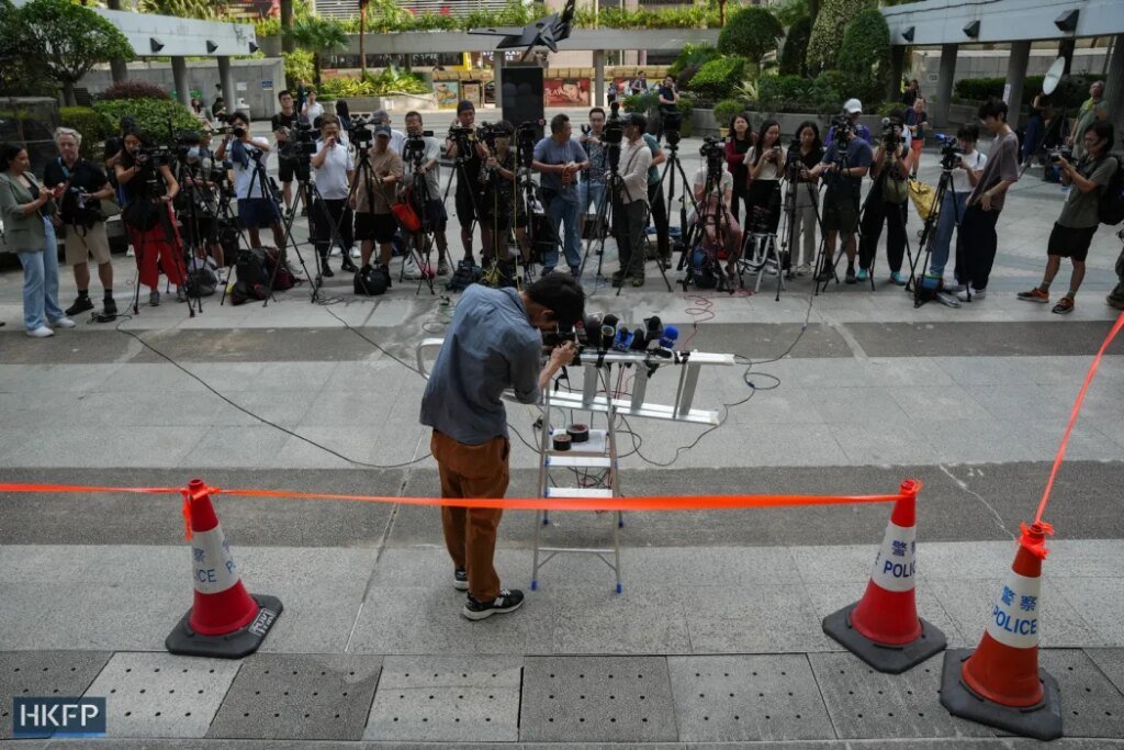 Journalists wait outside Wan Chai's District Court after a verdict was delivered in the sedition case of defunct Hong Kong media outlet Stand News, on August 19, 2024. Photo: Kyle Lam/HKFP.