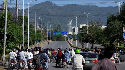 Pakistani police officers and Army soldiers divert the traffic on a road leading to the Serena hotel, the venue for the second phase of peace talks between the United States and Iran hosted by Pakistan, in Islamabad, April 20. (REUTERS)