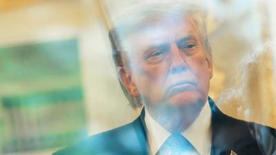 News photographers wait for US President Donald Trump to walk out of the Oval Office to speak with reporters at the White House in Washington, DC. (REUTERS)